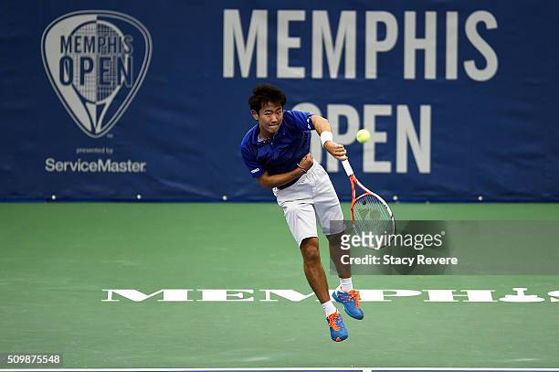 Yoshihito Nishioka of Japan serves to Sam Querrey of the United States during their quarterfinal singles match on Day 5 of the Memphis Open at the...