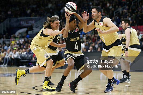 S Nick Cannon splits the defence of Canada's Win Butler and Drew Scott. NBA all star Celebrity game is 1st half action at Ricoh Coliseum, all part of...