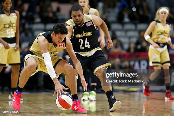 Milos Raonic battles for a loose ball with Anthony Anderson. NBA all star Celebrity game is 1st half action at Ricoh Coliseum, all part of the NBA...