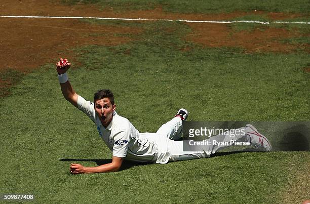 Trent Boult of New Zealand celebrates after taking a catch off his own bowling to dismiss Mitch Marsh of Australia during day two of the Test match...