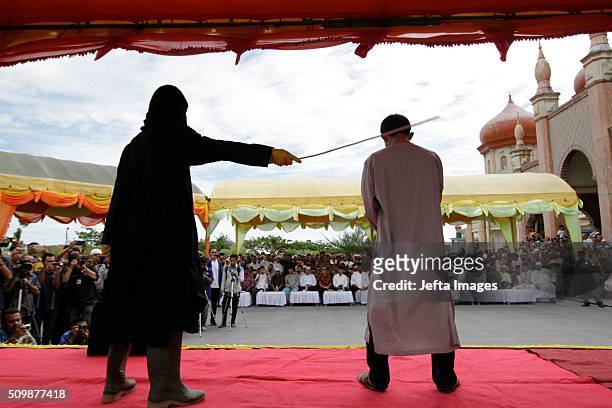 Man is whipped publicly in a caning ceremony at Meulabohm on February 12, 2016 in West Aceh, Indonesia. About 32 men in Aceh were publicly whipped on...