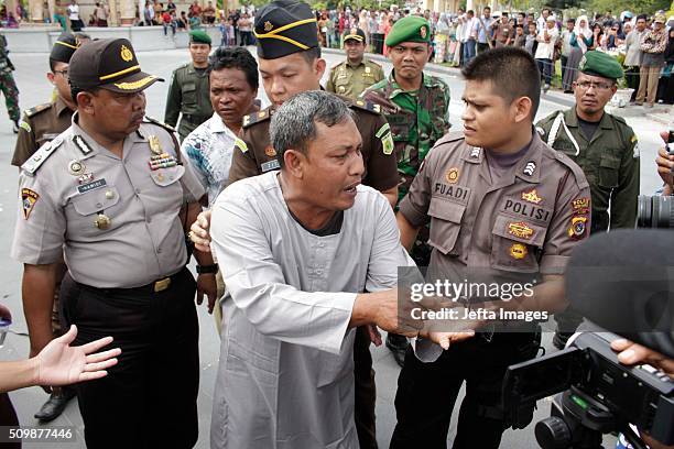 An alleged law violator is taken to the publicly whipping ceremony at Meulaboh on February 12, 2016 in West Aceh, Indonesia. About 32 men in Aceh...