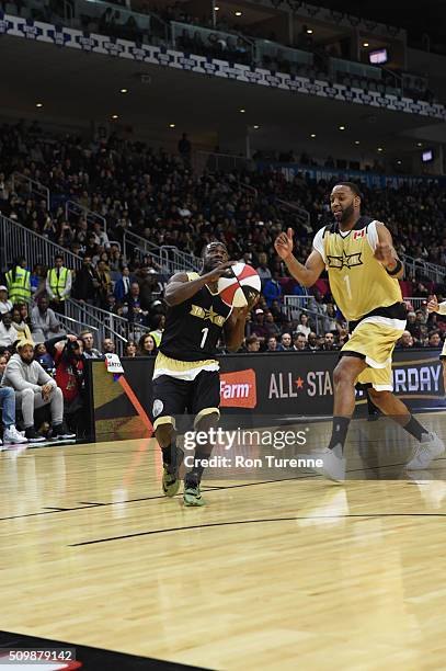 Kevin Hart of Team USA drives against Tracy McGrady of Team Canada during the NBA All-Star Celebrity Game Presented by Mountain Dew as part of 2016...