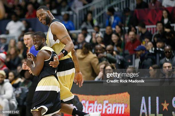 Coach Kevin Hart, who substituted in, runs back up court with Canada's Tracy McGrady. Hart was covering McGrady on defence. NBA all star Celebrity...