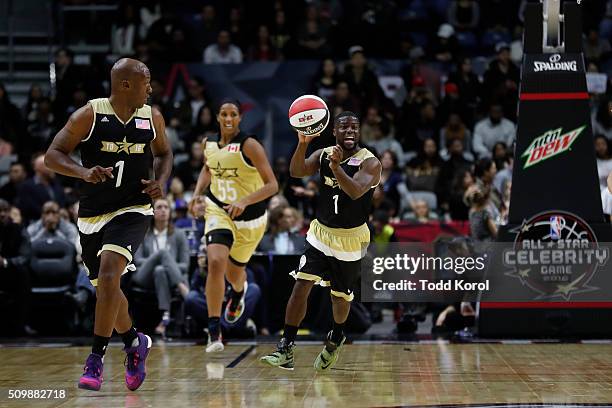 Team USA's head coach Kevin Hart passes the ball during the annual celebrity game against Team Canada, part of the NBA all-star weekend in Toronto,...