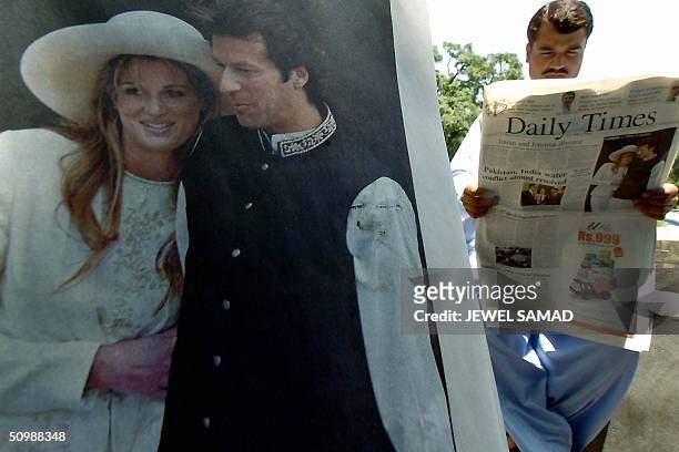 Pakistani man reads a national daily featuring on its front page a picture of former Pakistani cricket hero turned politician Imran Khan and his...