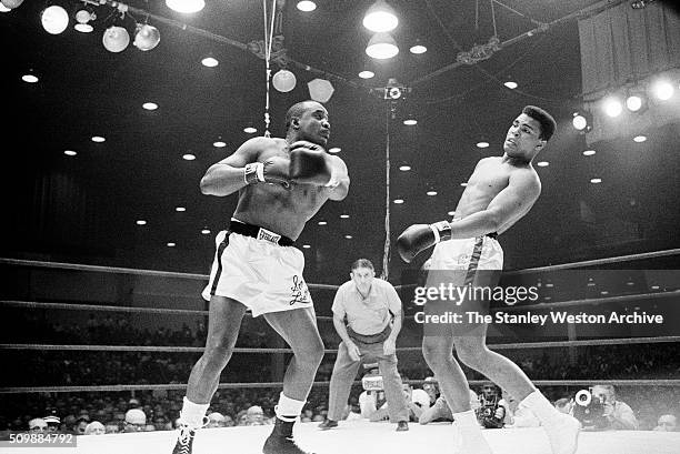 Sonny Liston throws a punch against Cassius Clay who slipps the punch during their bout at the Convention Center in Miami Beach, Florida, February...