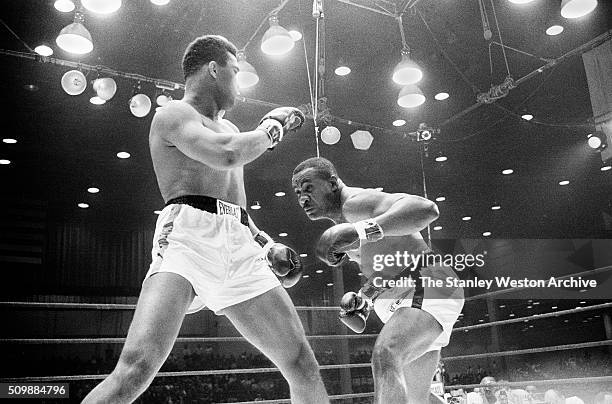 Cassius Clay uses the shoulder roll to defend against Sonny Liston at the Convention Center in Miami Beach, Florida, February 25, 1964. Cassius Clay...