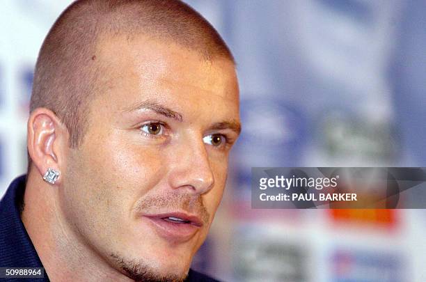 England's captain and midfielder David Beckham answers journalists' questions 23 June 2004 during a press conference in Lisbon Portugal during the...