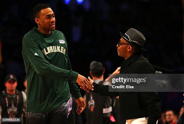 Jabari Parker of the Milwaukee Bucks and the United States team shakes hands with Director Spike Lee on from the sidelines in the second half between...