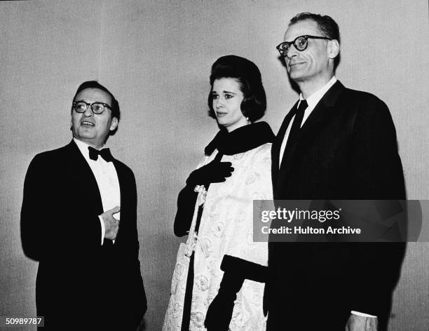 American film director Sidney Lumet stands with hand inside his tuxedo jacket pocket next to his second wife American heiress and designer Gloria...