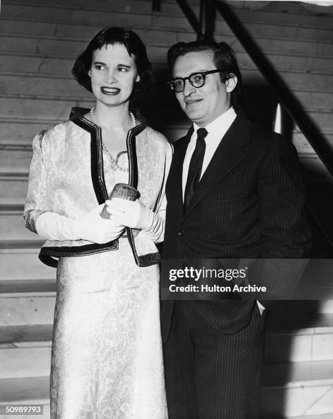 American heiress and designer Gloria Vanderbilt and her second husband American film director Sidney Lumet stand together at the foot of a marble...