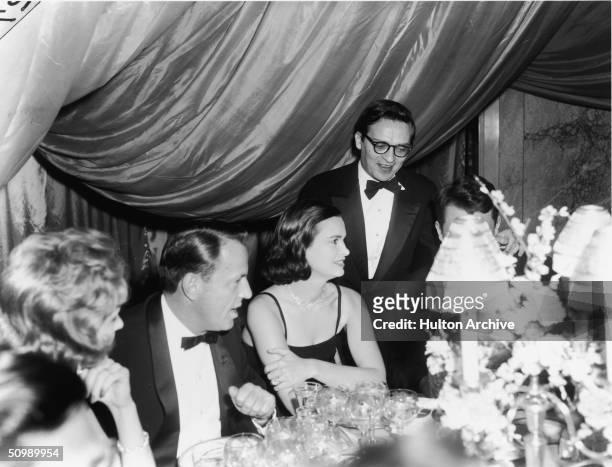 American heiress and designer Gloria Vanderbilt and her husband American film director at the Embassy Ball, at the Waldorf-Astoria, New York, early...