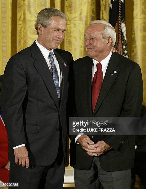 President George W. Bush jokes with US golf legend Arnold Palmer before presenting the Presidential Medal of Freedom, the nation's highest civil...