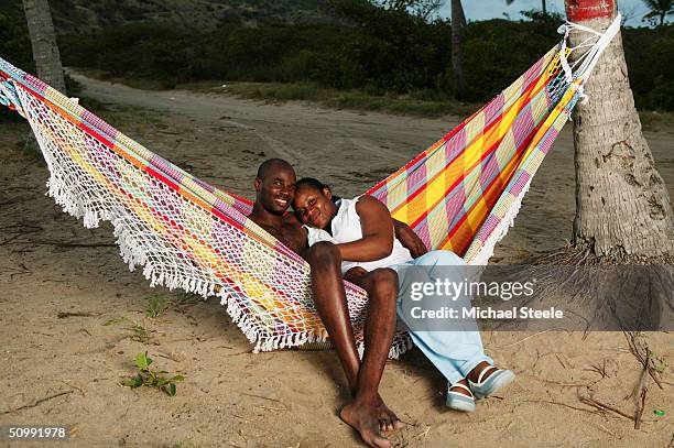 Kim Collins, 100m sprinter of St Kitts and Nevis and Olympic contender for Athens at home with his girlfriend Isis on April 21, 2004 in Frigate Bay,...