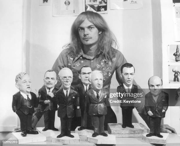 Artist Alan Aldridge with models of Conservative politicians used in posters for the Labour Party's 1970 election campaign under the slogan...