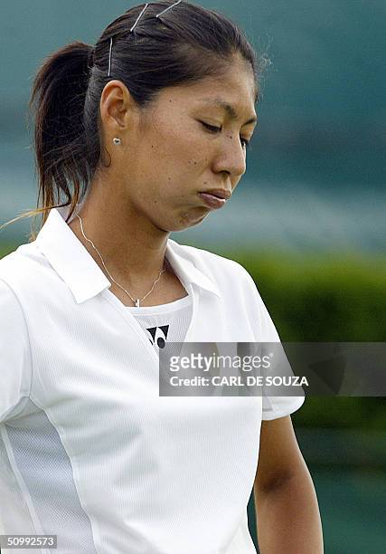 Shinobu Asagoe reacts to losing a point to Lisa Raymond of the US during the 118th Wimbledon Tennis Championships in Wimbledon, London 24 June, 2004....
