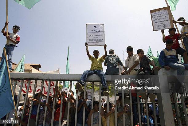 Palestinian boys from the Mini Palestinian Parliament, based in Rafah, shout anti-American and anti-Israeli slogans in front of the office of the...