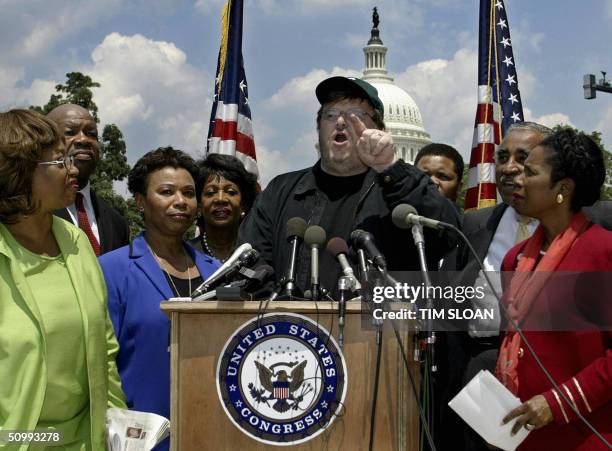 Filmmaker Michael Moore makes remarks at a press conference sponsored by the Congressional Black Caucus to talk about the war in Iraq, shared...