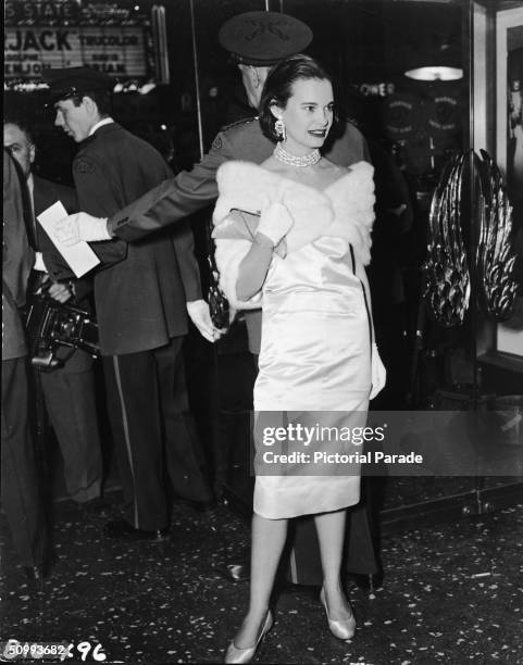 American heiress and socialite Gloria Vanderbilt poses for photographers outside the Astor Theater before the premiere of Elia Kazan's 'East of...