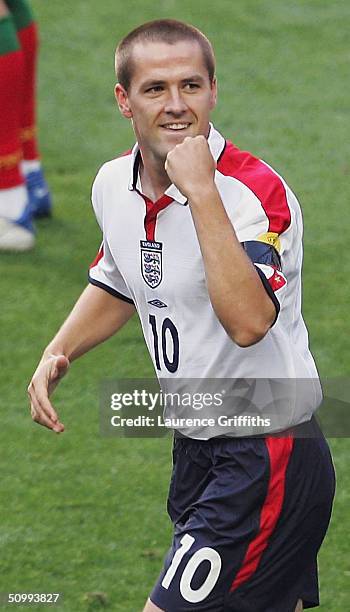 Michael Owen of England celebrates scoring the opening goal with David Beckham during the UEFA Euro 2004, Quarter Final match between Portugal and...