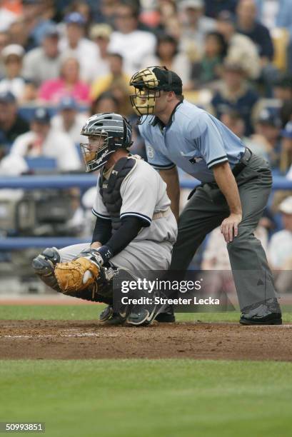 Catcher John Flaherty of the New York Yankees and home plate umpire Dan Iassogna behind the plate during the game against the Los Angeles Dodgers on...