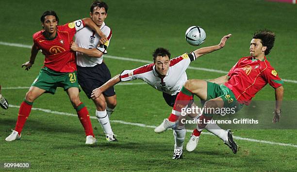 John Terry of England clears the ball away from Helder Postiga of Portugal during the UEFA Euro 2004, Quarter Final match between Portugal and...