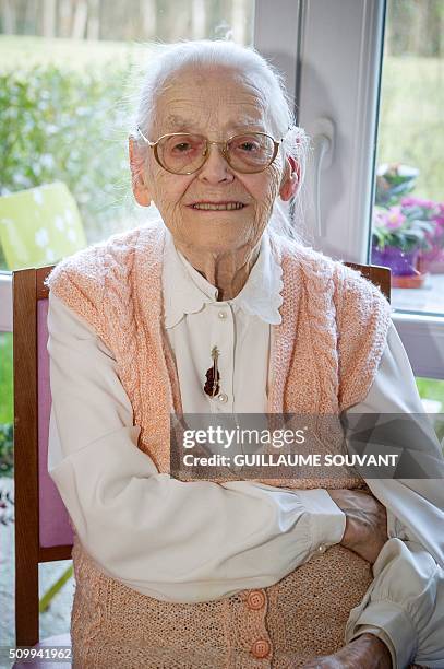 Centenary twins, Paulette Olivier poses inside her room at the retirement home "Les Bois Blancs" on February 11, 2016. The twins, birth name Lamolie,...