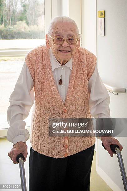 Centenary twins, Paulette Olivier walks in a corridor at the retirement home "Les Bois Blancs" on February 11, 2016. The twins, birth name Lamolie,...