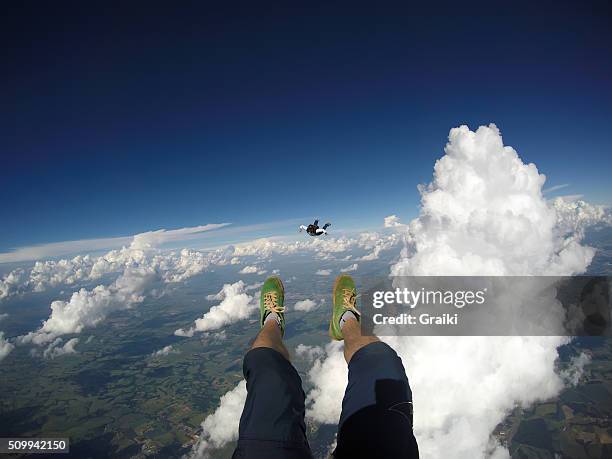 skydive lying in the clouds - pov shoes stock-fotos und bilder