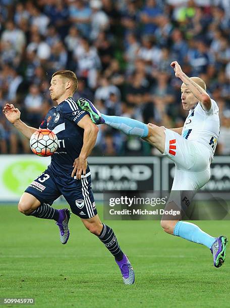 Oliver Bozanic of the Victory and Aaron Mooy of the City compete for the ball during the round 19 A-League match between Melbourne City FC and...