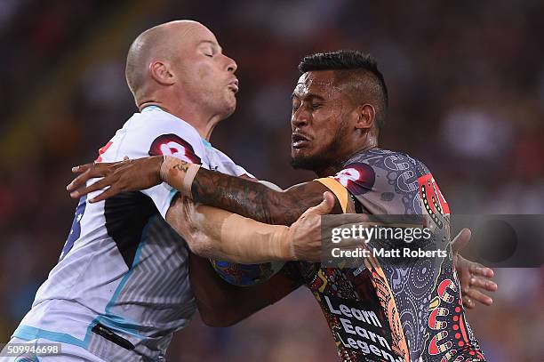 Ben Barba of the Indigenous All Stars is tackled by Beau Scott of the World All Stars during the NRL match between the Indigenous All-Stars and the...