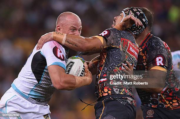 Beau Scott of the World All Stars is tackled by Jamie Soward of the Indigenous All Stars during the NRL match between the Indigenous All-Stars and...