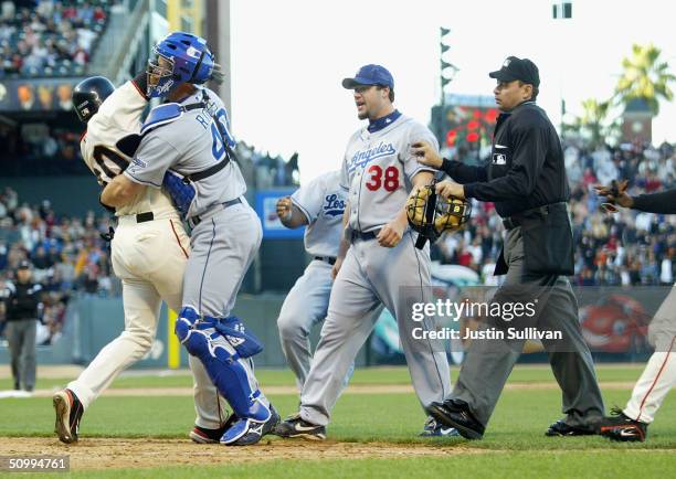 Michael Tucker of the San Francisco Giants is tackled by David Ross the Los Angeles Dodgers as he tried to charge the mound to get to Dodger pitcher...