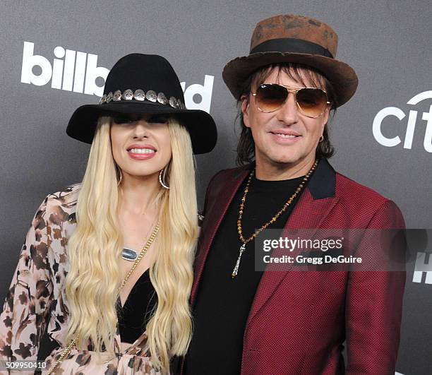 Musicians Orianthi and Richie Sambora arrive at the 2016 Billboard Power 100 Celebration at Bouchon on February 12, 2016 in Beverly Hills, California.