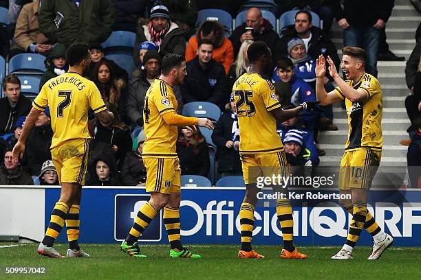 Tom Cairney of Fulham celebrates scoring the third goal with fellow goalscorers Moussa Dembele and Ross McCormack during the Sky Bet Championship...