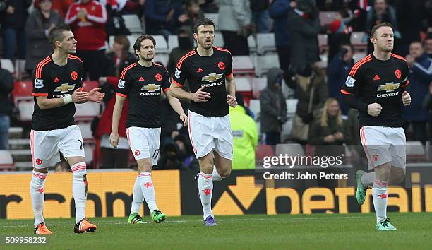 Morgan Schneiderlin, Daley Blind, Michael Carrick and Wayne Rooney of Manchester United react to Wahbi Khazri of Sunderland scoring their first goal...