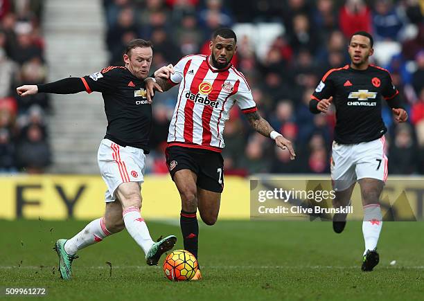 Yann M'Vila of Sunderland and Wayne Rooney of Manchester United compete for the ball during the Barclays Premier League match between Sunderland and...