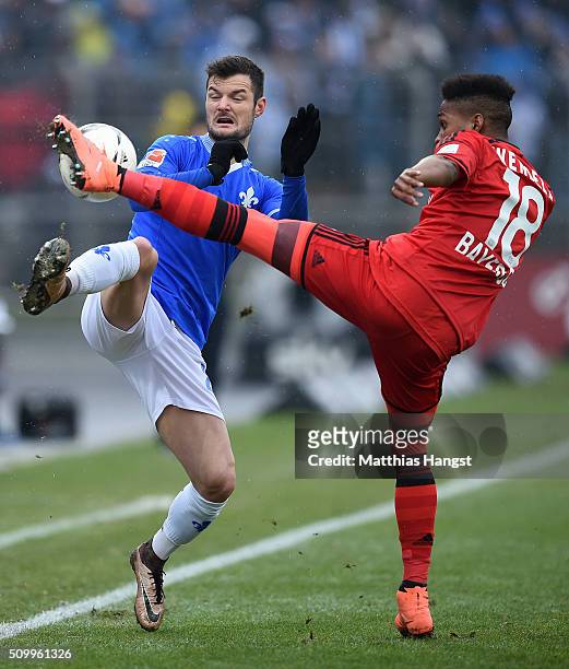 Marcel Heller of Darmstadt and Wendell of Leverkusen compete for the ball during the match between SV Darmstadt 98 and Bayer Leverkusen at...