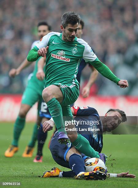 Fin Bartels of Bremen is challenged by Ermin Bicakcic of Hoffenheim during the Bundesliga match between Werder Bremen and 1899 Hoffenheim at...