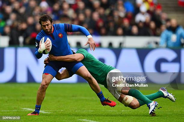 Maxime Medard of France is tackled Mike McCarthy of Ireland during the RBS Six Nations match between France and Ireland at the Stade de France on...