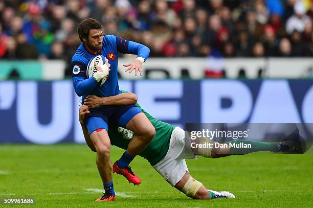 Maxime Medard of France is tackled Mike McCarthy of Ireland during the RBS Six Nations match between France and Ireland at the Stade de France on...