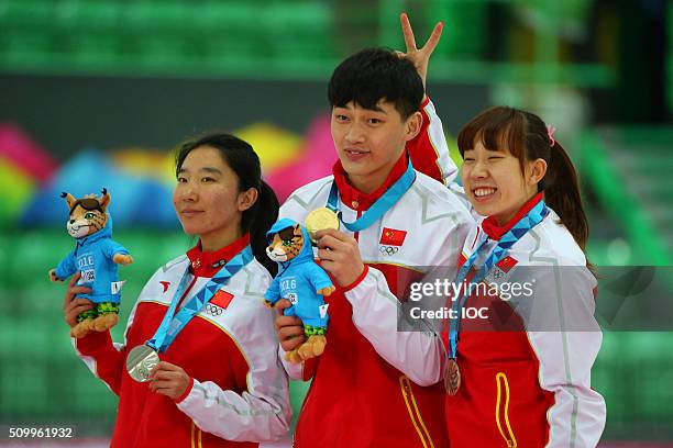 In this handout image supplied by the IOC, Men's 500m Speed Skating Gold medallist Li Yanzhe of China poses with Ladies 500m silver medallist Han Mei...