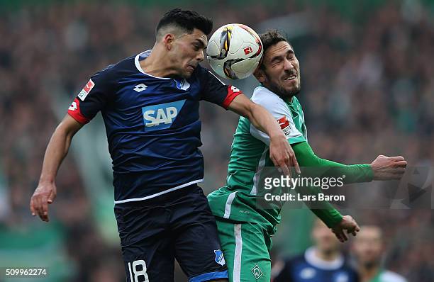 Nadiem Amiri of Hoffenheim goes up for a header with Santiago Garcia of Bremen during the Bundesliga match between Werder Bremen and 1899 Hoffenheim...
