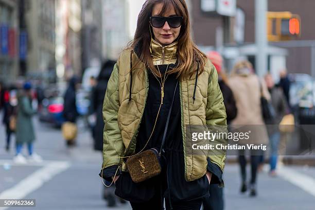 Ece Sukan wearing an olive-green bomber jacket and a leopard patterned bomber jacket seen outside Creatures of the Wind during New York Fashion Week:...