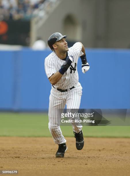 Infielder Derek Jeter of the New York Yankees runs the baseline against the Colorado Rockies during the interleague game at Yankee Stadium on June...