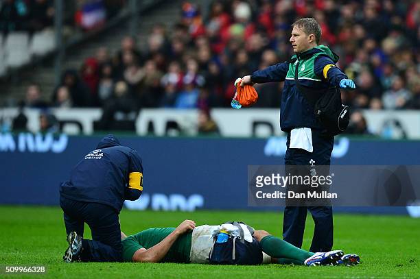 Mike McCarthy of Ireland receives medical treatment during the RBS Six Nations match between France and Ireland at the Stade de France on February...