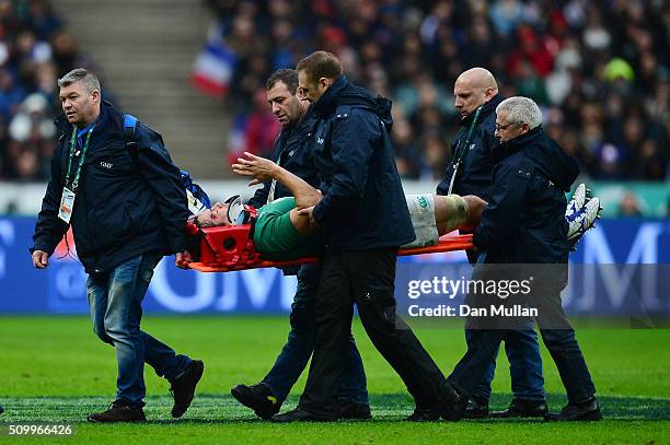 The injured Mike McCarthy of Ireland waves to the fans as he is stretchered off the pitch during the RBS Six Nations match between France and Ireland...