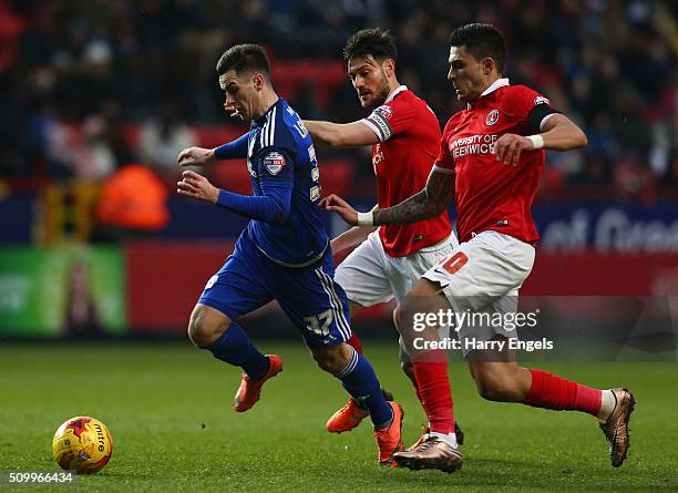 Tom Lawrence of Cadiff is challenged by Johnnie Jackson and Jorge Teixeira of Charlton during the Sky Bet Championship match between Charlton...