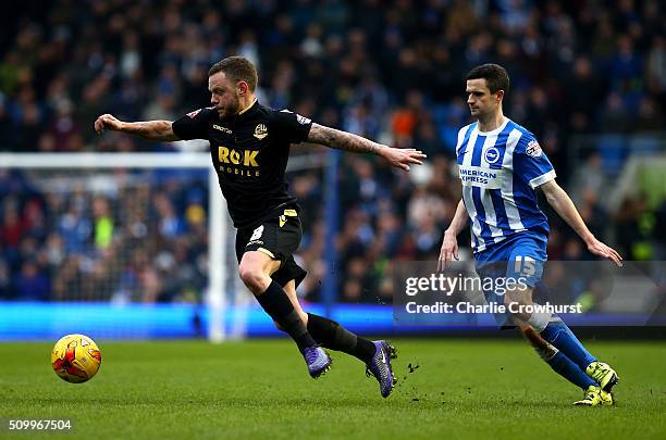 Jay Spearing of Bolton looks to break away from Brighton's Jamie Murphy during the Sky Bet Championship match between Brighton and Hove Albion and...